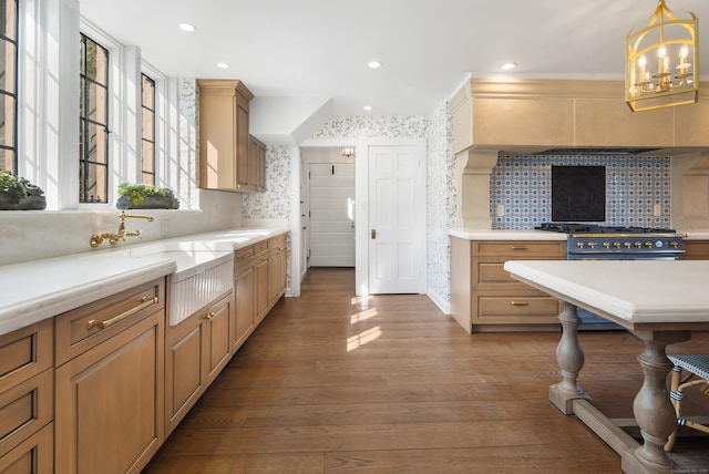 kitchen featuring wood finished floors, a notable chandelier, light countertops, backsplash, and recessed lighting