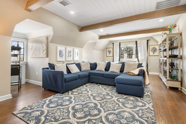 living area with vaulted ceiling with beams, hardwood / wood-style flooring, baseboards, and visible vents