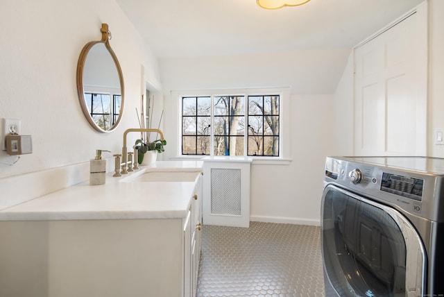 laundry room with washer / dryer, tile patterned flooring, a sink, and baseboards