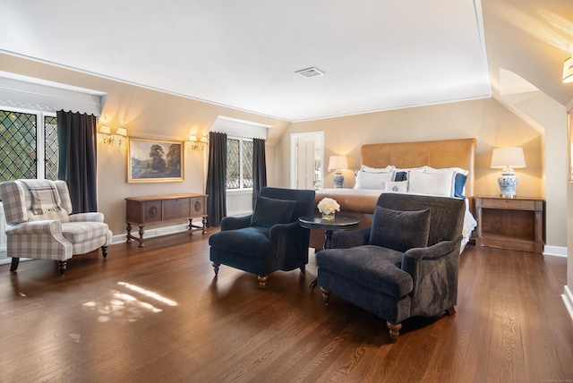 bedroom featuring visible vents, baseboards, and wood finished floors