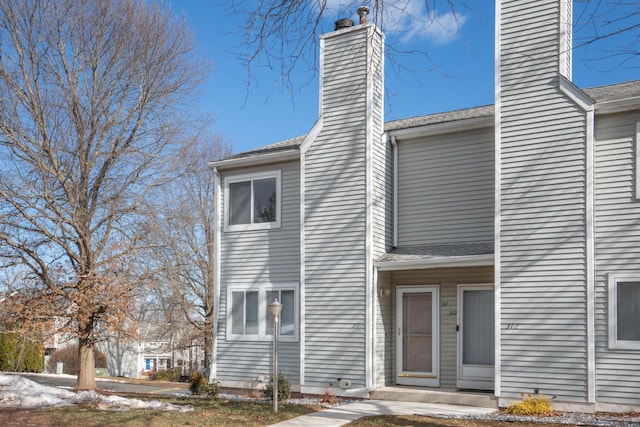 view of front facade with a chimney