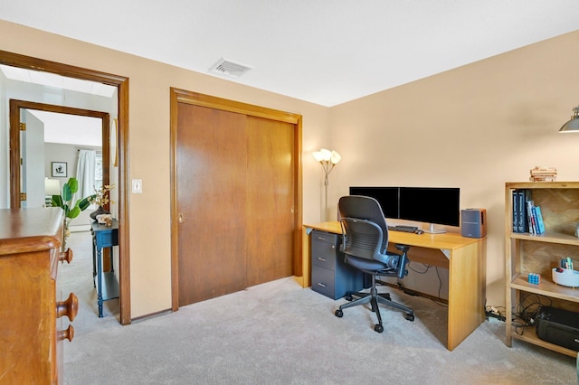 office space with visible vents and light colored carpet