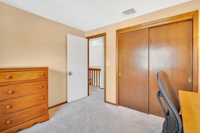 office space with baseboards, visible vents, and light colored carpet