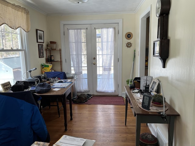 doorway to outside with french doors, crown molding, and wood finished floors