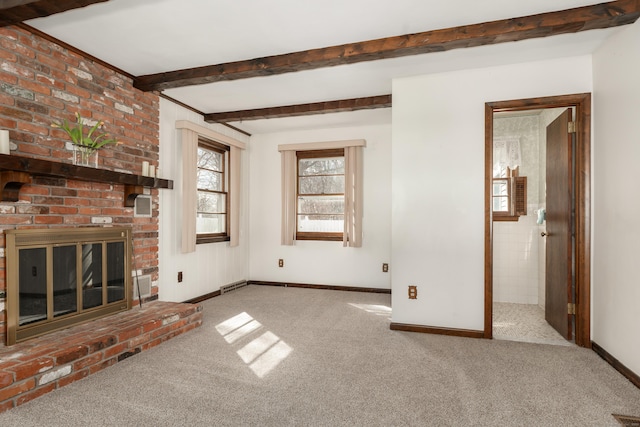 unfurnished living room with beamed ceiling, carpet flooring, a fireplace, and baseboards