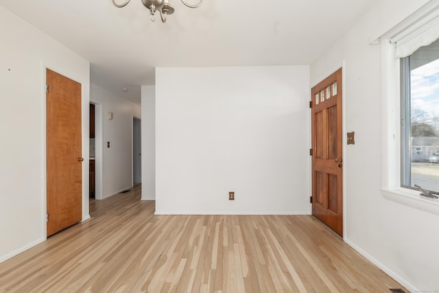 entryway with baseboards and light wood-style floors