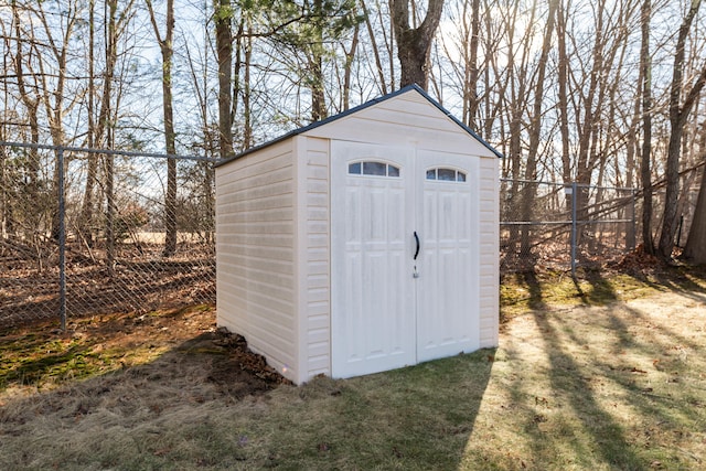 view of shed featuring fence