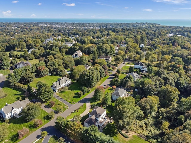 birds eye view of property featuring a water view and a forest view