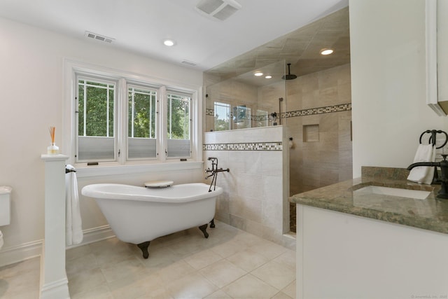 bathroom with a soaking tub, visible vents, vanity, and walk in shower