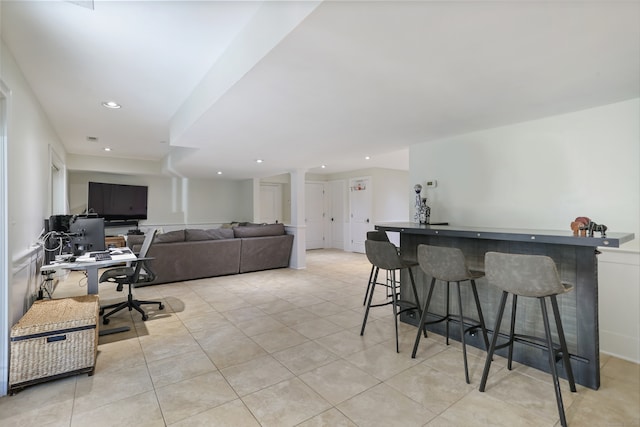 office space featuring light tile patterned floors, a dry bar, and recessed lighting