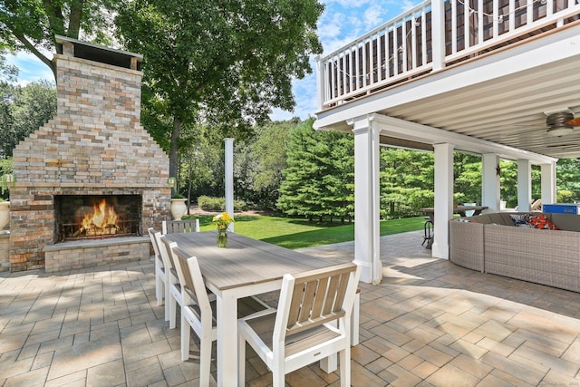 view of patio / terrace featuring outdoor dining area and an outdoor living space with a fireplace