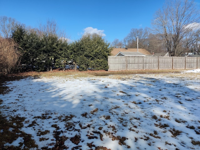 snowy yard with fence