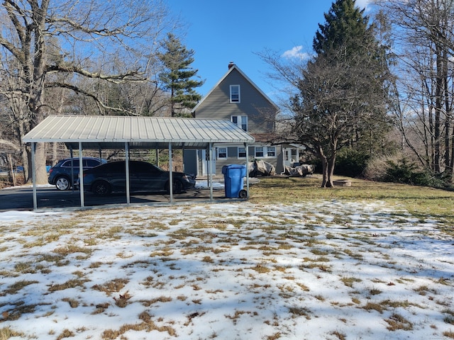 exterior space with a carport, a standing seam roof, and metal roof