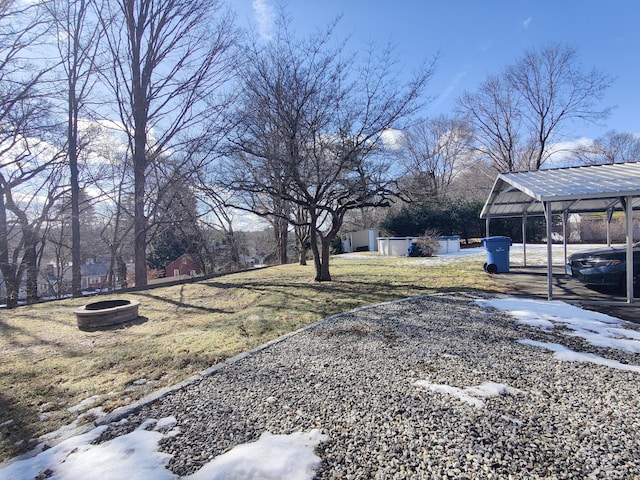 view of yard with an outdoor fire pit and a detached carport