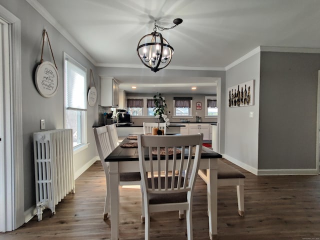 dining space featuring dark wood-style floors, baseboards, ornamental molding, and radiator heating unit