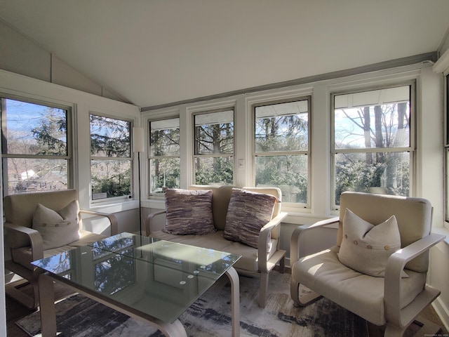 sunroom / solarium featuring vaulted ceiling