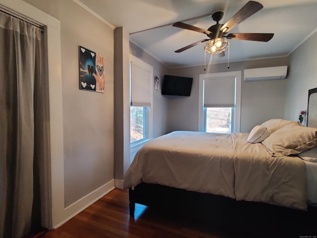 bedroom with baseboards, wood finished floors, crown molding, and a wall mounted AC