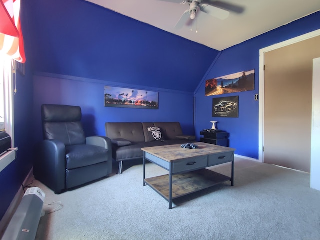 home theater with a ceiling fan, carpet flooring, and vaulted ceiling