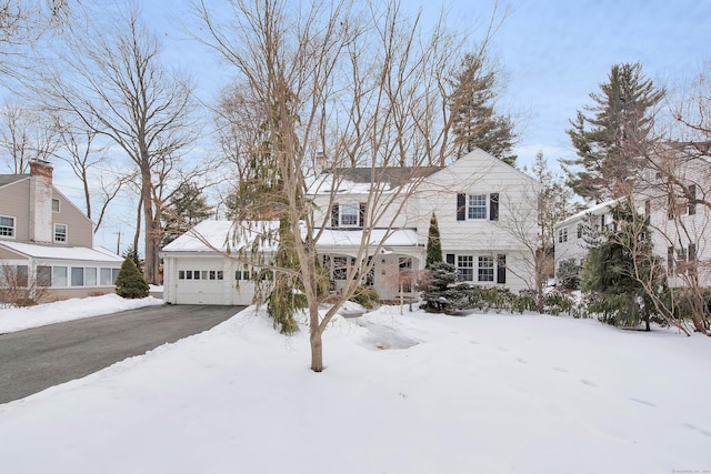 traditional-style home featuring a garage and driveway