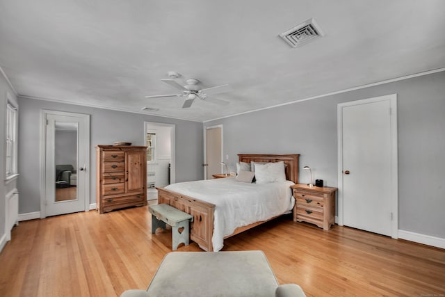 bedroom featuring a ceiling fan, baseboards, visible vents, light wood finished floors, and crown molding