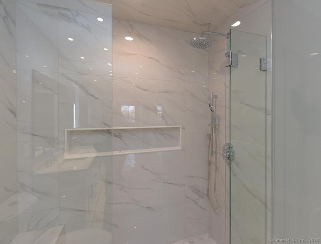 bathroom featuring recessed lighting and a marble finish shower