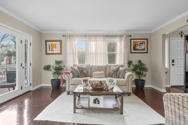 living room featuring ornamental molding, baseboards, and wood finished floors