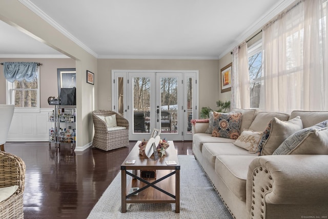 living area featuring french doors, crown molding, and wood finished floors