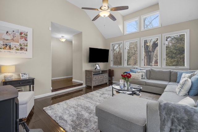 living area featuring dark wood-style floors, ceiling fan, baseboards, and high vaulted ceiling