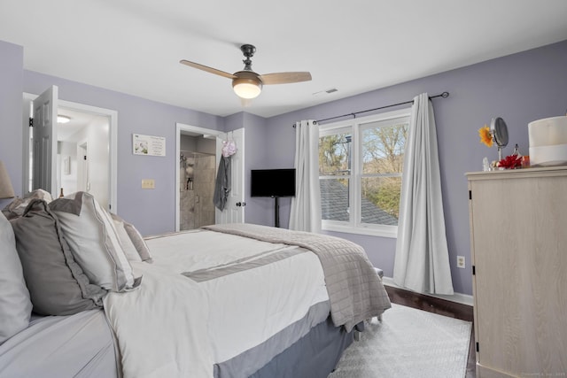 bedroom with ceiling fan, ensuite bath, visible vents, and baseboards