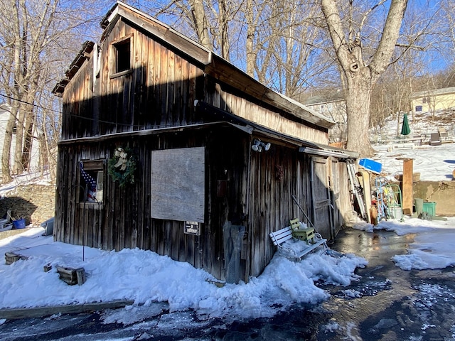 view of snowy exterior featuring an outdoor structure