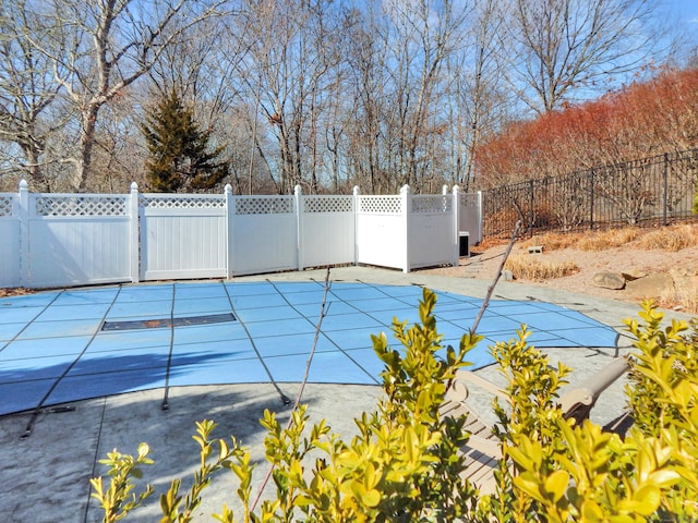 view of swimming pool featuring a patio area, fence private yard, and a fenced in pool