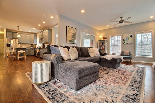 living area featuring baseboards, a ceiling fan, dark wood-type flooring, and recessed lighting