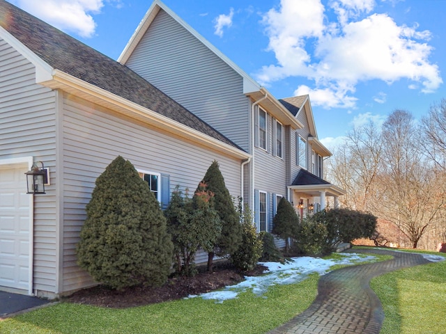 view of side of property with a garage