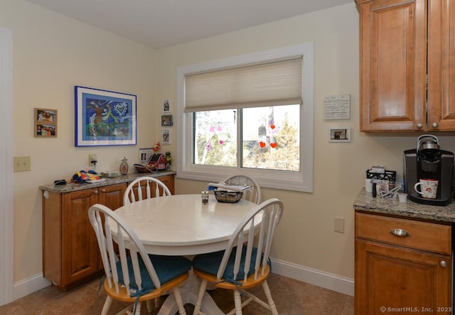 dining area featuring baseboards and light tile patterned floors
