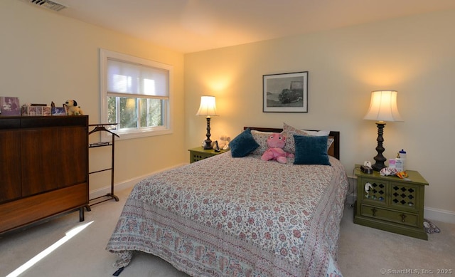 carpeted bedroom featuring visible vents and baseboards