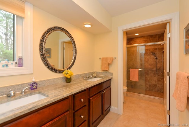 full bathroom with a shower stall, toilet, and a sink