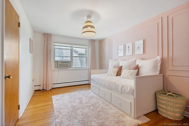 29 Maplewood Dr, Greenwich, CT 06807 - bedroom with cooling unit, wood finished floors, and baseboard heating