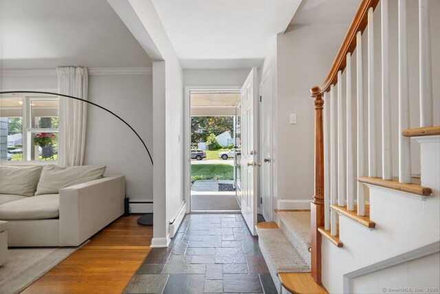 29 Maplewood Dr, Greenwich, CT 06807 - foyer entrance with stone tile floors, baseboards, stairway, a baseboard radiator, and ornamental molding