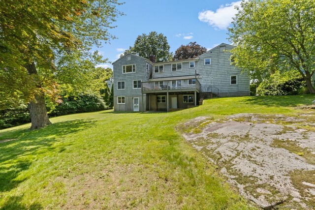29 Maplewood Dr, Greenwich, CT 06807 - back of property featuring a deck and a lawn