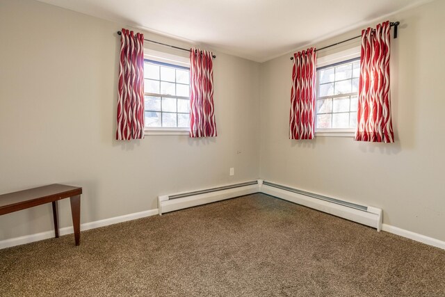 carpeted spare room featuring a baseboard radiator and baseboards