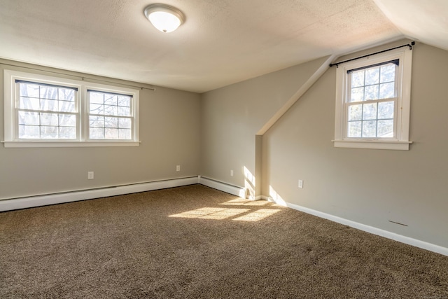 carpeted empty room with lofted ceiling, plenty of natural light, and baseboards