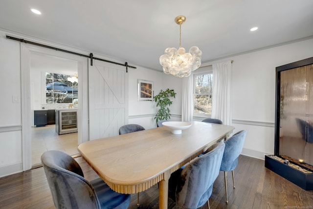 dining space with wood finished floors, recessed lighting, a barn door, wine cooler, and a chandelier