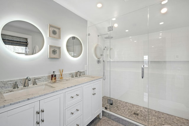 full bath featuring double vanity, recessed lighting, a shower stall, and a sink