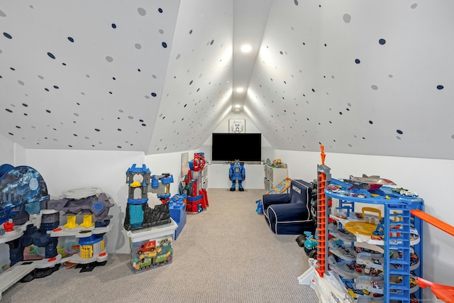 recreation room with lofted ceiling and carpet floors