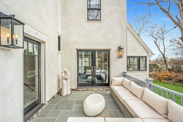 property entrance with stucco siding, an outdoor hangout area, and french doors