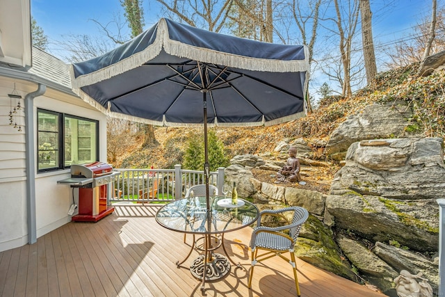 wooden deck with a grill