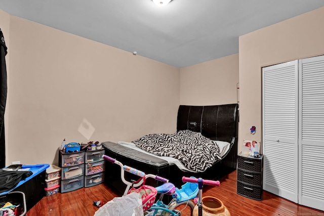 bedroom with a closet and wood finished floors