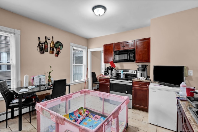 kitchen with black microwave, a baseboard radiator, light tile patterned flooring, refrigerator, and stainless steel electric range oven