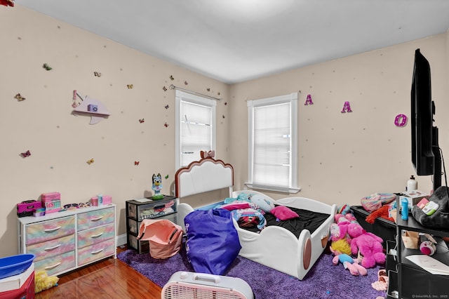 bedroom featuring baseboards and wood finished floors