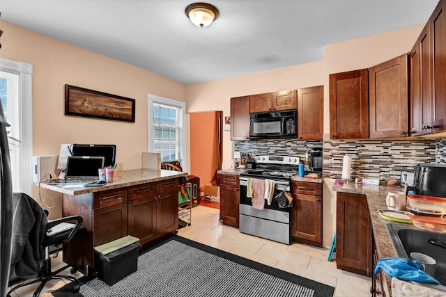 kitchen featuring light tile patterned floors, electric range, decorative backsplash, a sink, and black microwave